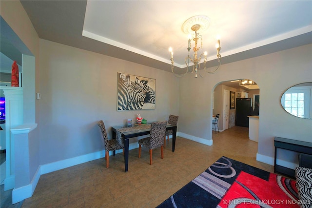 919 S 2nd St, Mcalester, OK 74501 - dining room with arched walkways, a chandelier, and a tray ceiling