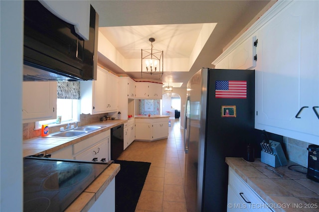 919 S 2nd St, Mcalester, OK 74501 - kitchen with white cabinets, a chandelier, tasteful backsplash, and black appliances