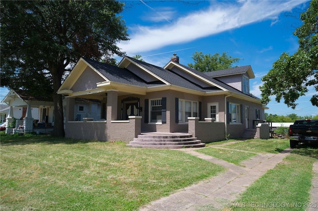 919 S 2nd St, Mcalester, OK 74501 - view of front of house featuring a chimney, a front yard, brick siding, and a shingled roof