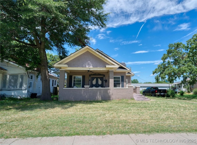 919 S 2nd St, Mcalester, OK 74501 - view of front of house with a front lawn, brick siding, and a ceiling fan