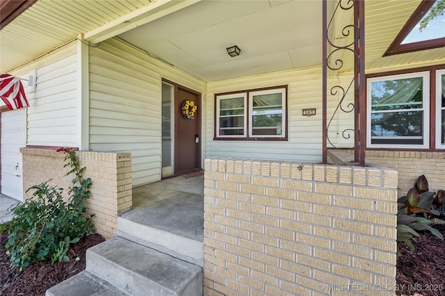 503 N Prairie Ave, Okmulgee, OK 74447 - doorway to property featuring covered porch and brick siding