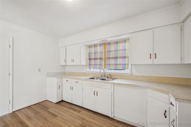 503 N Prairie Ave, Okmulgee, OK 74447 - kitchen with crown molding, light wood-style floors, light countertops, and white cabinetry