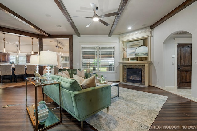 7180 E 179th St S, Bixby, OK 74008 - living area with ceiling fan, arched walkways, beam ceiling, a fireplace, and wood finished floors