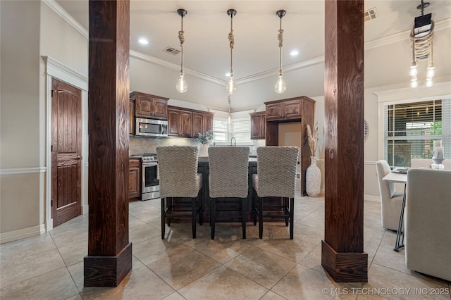 7180 E 179th St S, Bixby, OK 74008 - kitchen featuring stainless steel appliances, crown molding, light tile patterned floors, tasteful backsplash, and a kitchen island