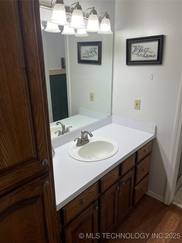 465385 E 981st Rd, Sallisaw, OK 74955 - bathroom featuring vanity and wood finished floors