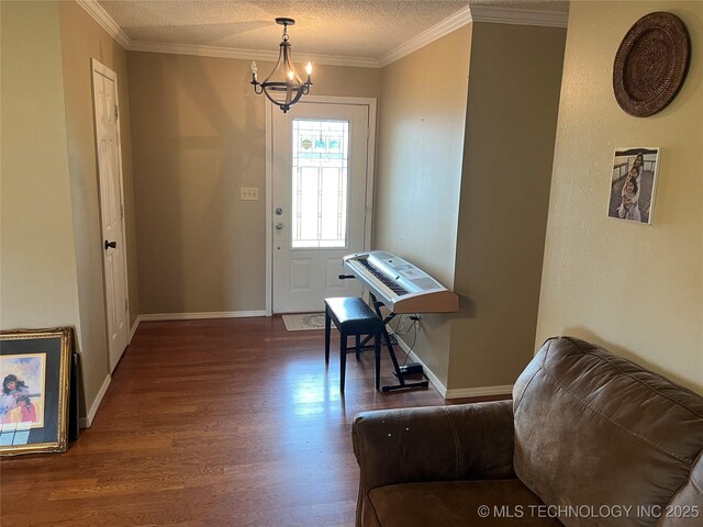 465385 E 981st Rd, Sallisaw, OK 74955 - entryway with wood finished floors, a chandelier, a textured ceiling, and ornamental molding