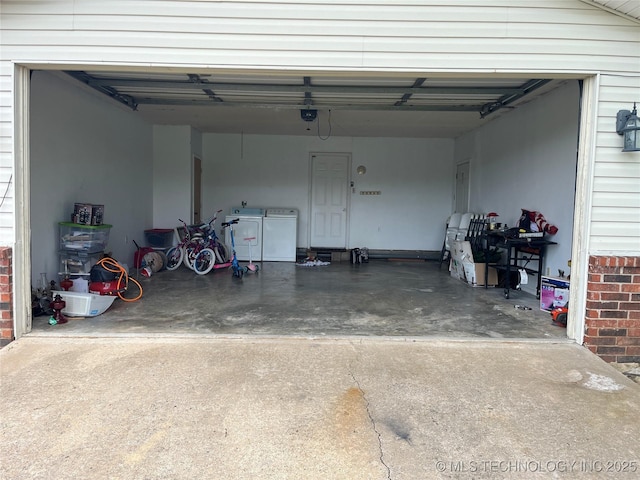 465385 E 981st Rd, Sallisaw, OK 74955 - garage with washing machine and dryer, concrete driveway, and a garage door opener