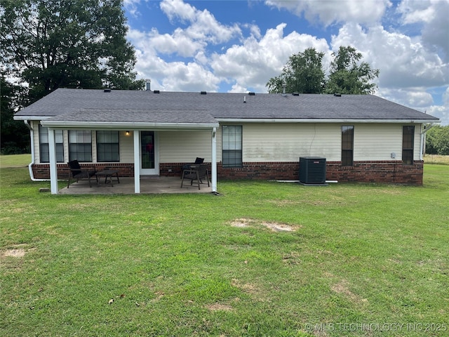 465385 E 981st Rd, Sallisaw, OK 74955 - back of house with brick siding, a patio area, a lawn, and a shingled roof