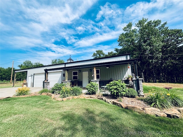 416602 E 1065, Checotah, OK 74426 - view of front facade with a front lawn, an attached garage, concrete driveway, and board and batten siding