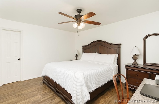 416602 E 1065, Checotah, OK 74426 - bedroom with wood finished floors and a ceiling fan