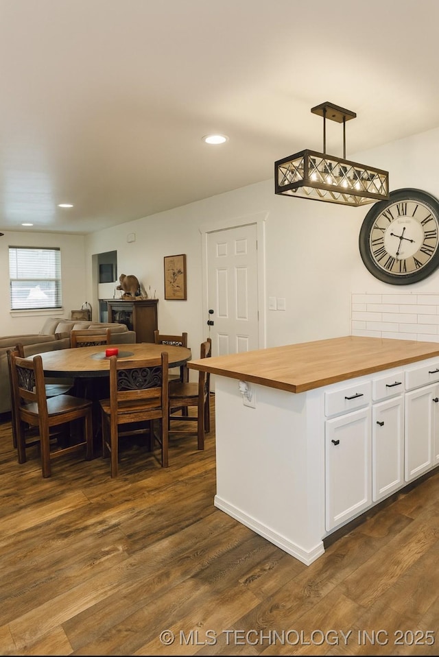 416602 E 1065, Checotah, OK 74426 - kitchen with butcher block countertops, white cabinetry, dark wood-style floors, open floor plan, and recessed lighting