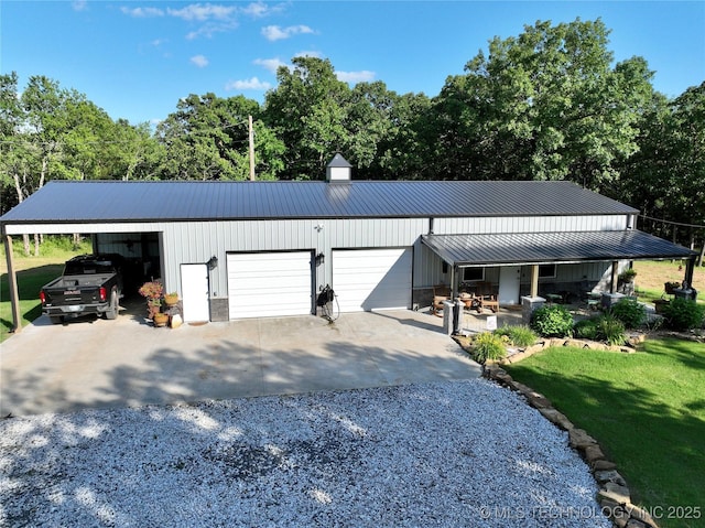 416602 E 1065, Checotah, OK 74426 - view of front of house featuring a metal roof, a front yard, driveway, and a garage
