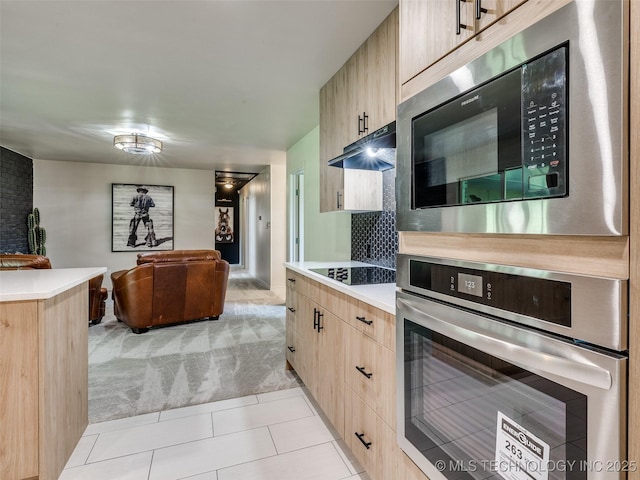 701 W 41st St, Sand Springs, OK 74063 - kitchen featuring stainless steel oven, light brown cabinets, built in microwave, light carpet, and under cabinet range hood