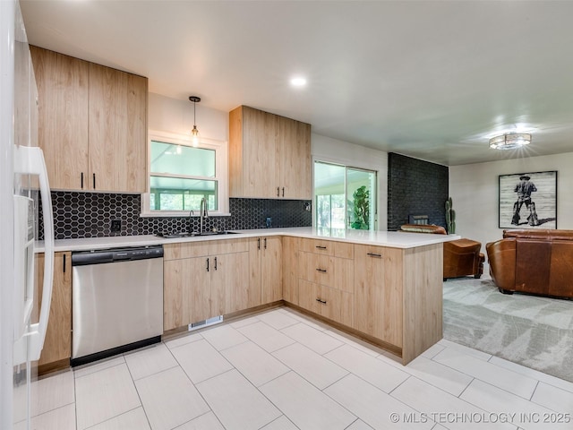 701 W 41st St, Sand Springs, OK 74063 - kitchen with stainless steel dishwasher, light brown cabinetry, a peninsula, and open floor plan