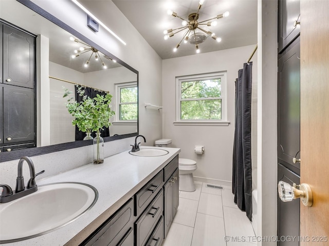 701 W 41st St, Sand Springs, OK 74063 - bathroom featuring double vanity, tile patterned floors, and a chandelier