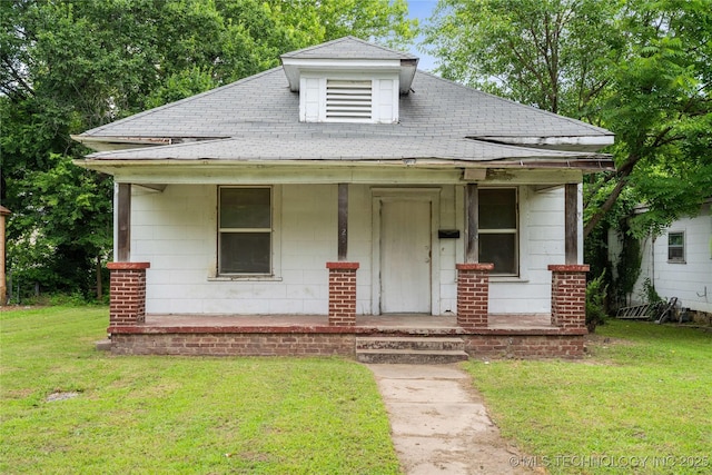1225 N C St, Muskogee, OK 74403 - bungalow-style house featuring covered porch, a front yard, and a shingled roof