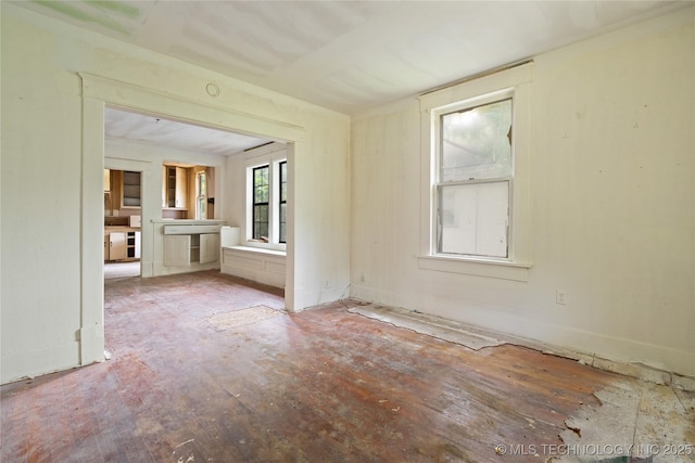 1225 N C St, Muskogee, OK 74403 - spare room featuring wood finished floors