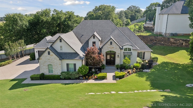 6140 E 140th St S, Bixby, OK 74008 - french provincial home with stone siding, stucco siding, french doors, and concrete driveway