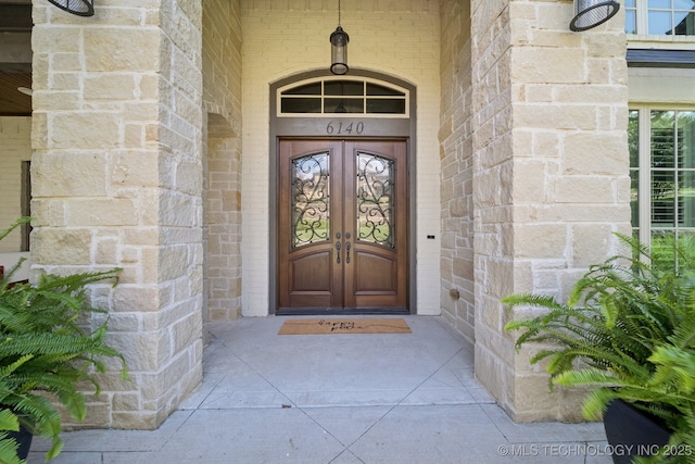 6140 E 140th St S, Bixby, OK 74008 - doorway to property featuring brick siding and french doors