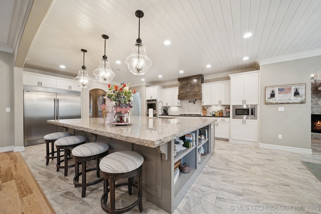 6140 E 140th St S, Bixby, OK 74008 - kitchen with built in appliances, premium range hood, recessed lighting, ornamental molding, and a spacious island