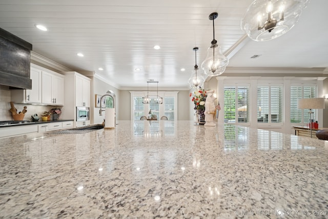 6140 E 140th St S, Bixby, OK 74008 - kitchen with ornamental molding, a chandelier, white cabinetry, light stone counters, and recessed lighting