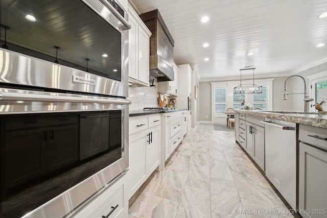 6140 E 140th St S, Bixby, OK 74008 - kitchen featuring stainless steel appliances, light marble finish flooring, ornamental molding, recessed lighting, and white cabinetry