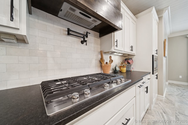 6140 E 140th St S, Bixby, OK 74008 - kitchen with stainless steel appliances, white cabinetry, ornamental molding, range hood, and backsplash