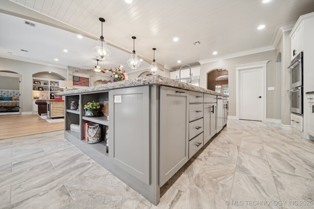 6140 E 140th St S, Bixby, OK 74008 - kitchen with arched walkways, a ceiling fan, recessed lighting, ornamental molding, and stainless steel double oven