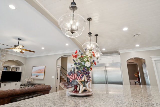 6140 E 140th St S, Bixby, OK 74008 - kitchen with built in refrigerator, arched walkways, light stone counters, ornamental molding, and recessed lighting