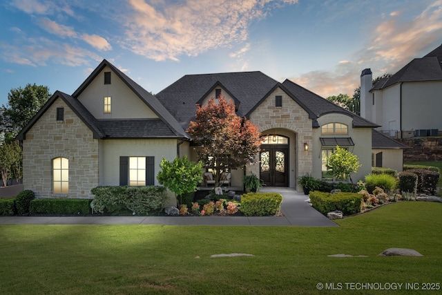 6140 E 140th St S, Bixby, OK 74008 - french country home featuring french doors, stone siding, and a front lawn