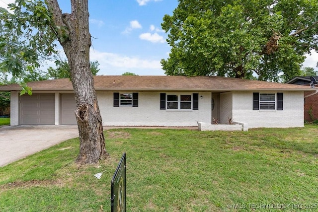 1706 S Madison Blvd, Bartlesville, OK 74006 - single story home with brick siding, an attached garage, and a front lawn