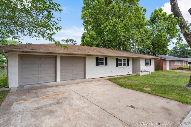 1706 S Madison Blvd, Bartlesville, OK 74006 - single story home featuring brick siding, concrete driveway, a front yard, and an attached garage