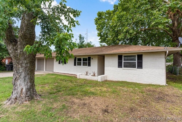 1706 S Madison Blvd, Bartlesville, OK 74006 - ranch-style home with brick siding, an attached garage, and driveway