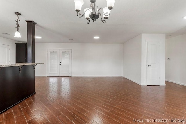 1706 S Madison Blvd, Bartlesville, OK 74006 - unfurnished living room with a chandelier, wood finished floors, and recessed lighting