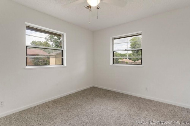 1706 S Madison Blvd, Bartlesville, OK 74006 - unfurnished room featuring carpet, a ceiling fan, and a textured ceiling