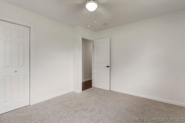 1706 S Madison Blvd, Bartlesville, OK 74006 - unfurnished bedroom featuring carpet and a ceiling fan