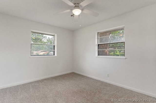1706 S Madison Blvd, Bartlesville, OK 74006 - carpeted spare room with plenty of natural light and a ceiling fan