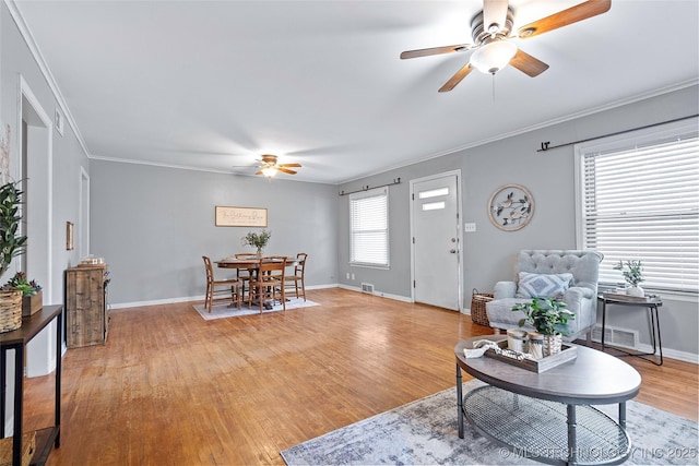 1809 Robison, Ardmore, OK 73401 - living room featuring ceiling fan, light wood-style flooring, and crown molding