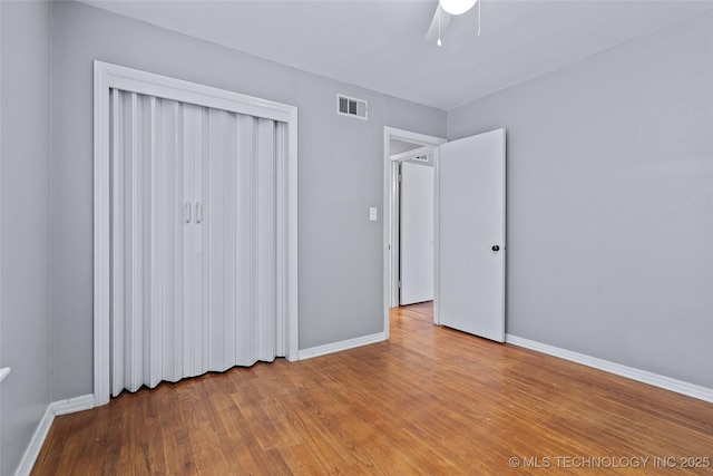1809 Robison, Ardmore, OK 73401 - unfurnished bedroom with wood finished floors, ceiling fan, and a closet
