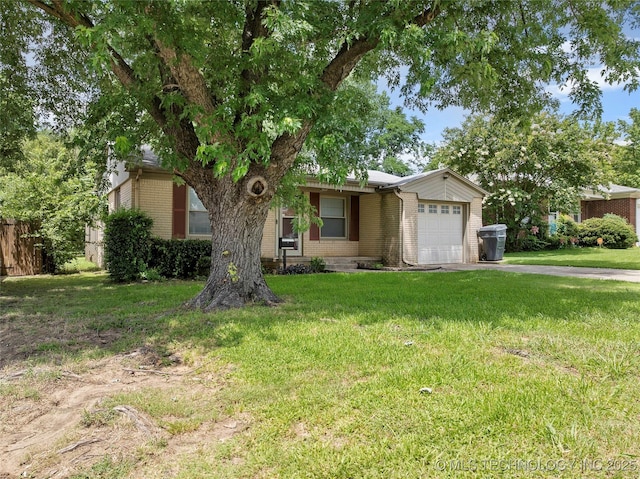 1809 Robison, Ardmore, OK 73401 - view of property hidden behind natural elements featuring a garage, brick siding, and driveway