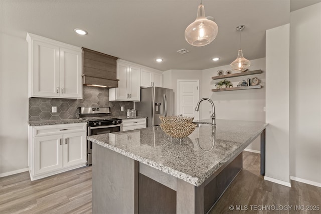 13009 E 124th Ct, Collinsville, OK 74021 - kitchen with stainless steel appliances, open shelves, light wood-type flooring, light stone counters, and white cabinets