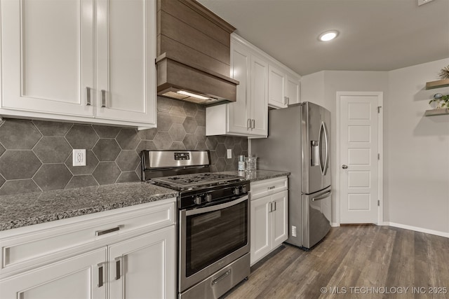13009 E 124th Ct, Collinsville, OK 74021 - kitchen with appliances with stainless steel finishes, custom exhaust hood, dark stone countertops, white cabinetry, and dark wood-style flooring