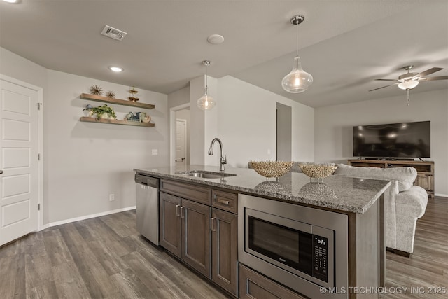 13009 E 124th Ct, Collinsville, OK 74021 - kitchen with stainless steel appliances, dark wood-style floors, open floor plan, and light stone countertops