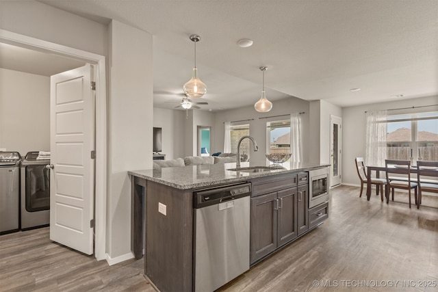 13009 E 124th Ct, Collinsville, OK 74021 - kitchen featuring stainless steel appliances, separate washer and dryer, wood finished floors, light stone counters, and pendant lighting