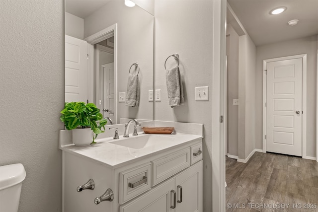 13009 E 124th Ct, Collinsville, OK 74021 - bathroom with vanity, wood finished floors, and recessed lighting