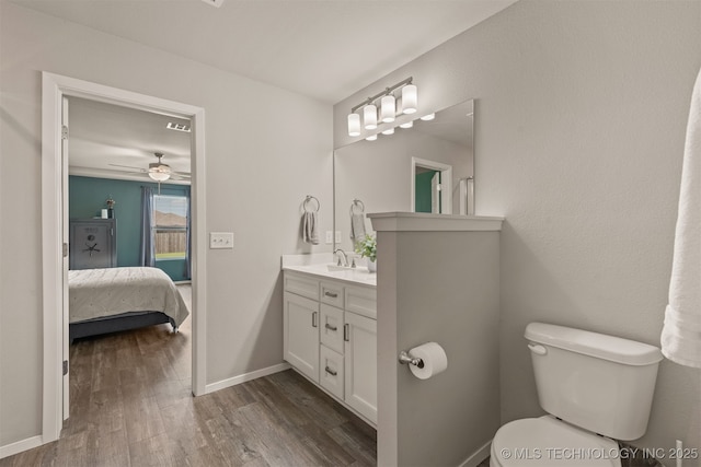 13009 E 124th Ct, Collinsville, OK 74021 - ensuite bathroom with vanity, wood finished floors, and a ceiling fan