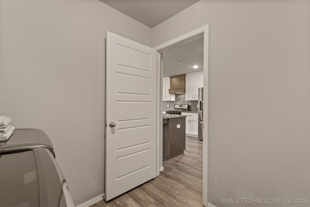 13009 E 124th Ct, Collinsville, OK 74021 - laundry area featuring light wood-style flooring and baseboards