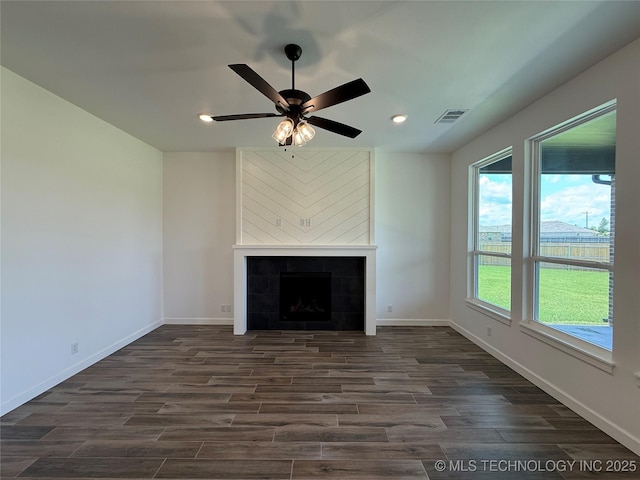 8940 E 161st Pl S, Bixby, OK 74008 - unfurnished living room featuring dark wood-type flooring, recessed lighting, ceiling fan, and a tile fireplace