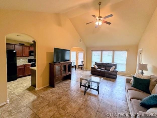18328 E 42nd St, Tulsa, OK 74134 - living room with arched walkways, high vaulted ceiling, ceiling fan, light tile patterned floors, and beam ceiling