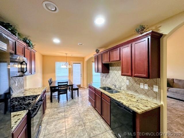 18328 E 42nd St, Tulsa, OK 74134 - kitchen featuring black appliances, reddish brown cabinets, arched walkways, and recessed lighting